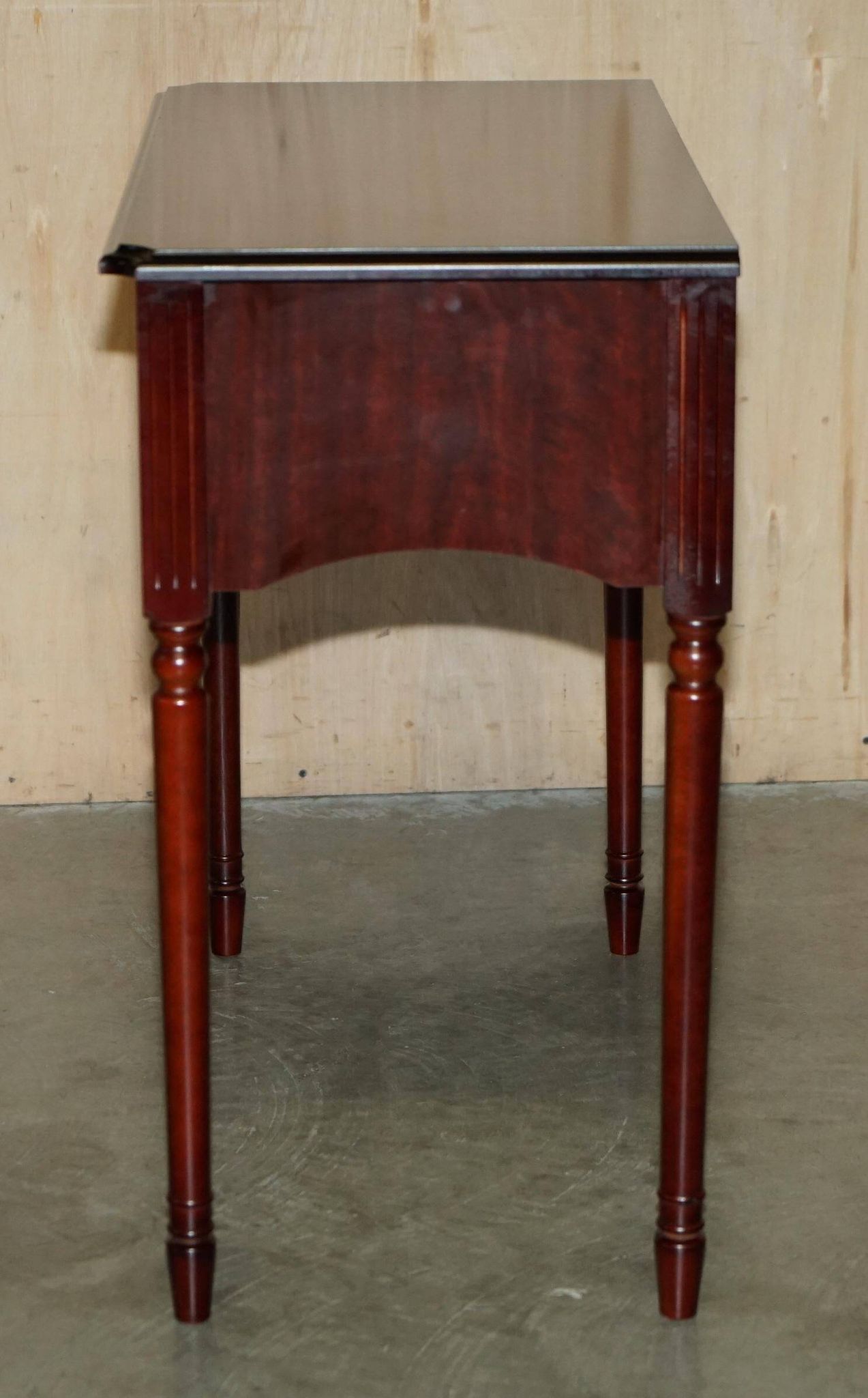 Small console with two drawers in hardwood finish.