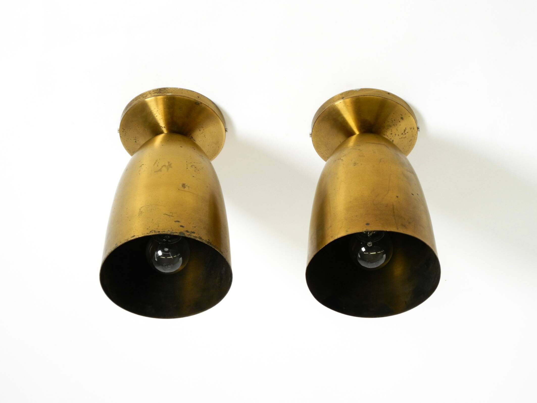 A pair of large, original Mid Century Modern brass ceiling lamps
