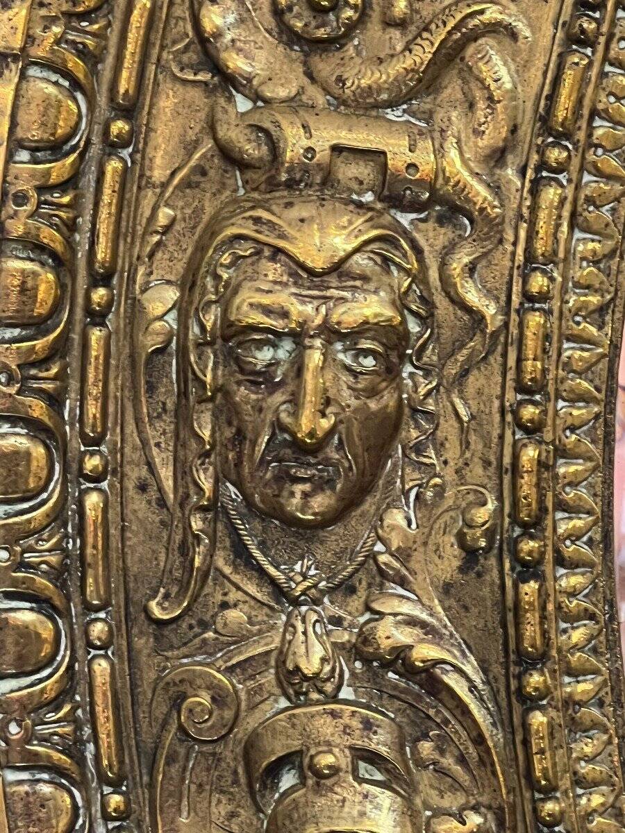 A. Arens, Antwerp, important oval mirror in repoussé brass with numerous animal decorations