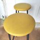 Pair of black metal bar stools and yellow imitation leather seat