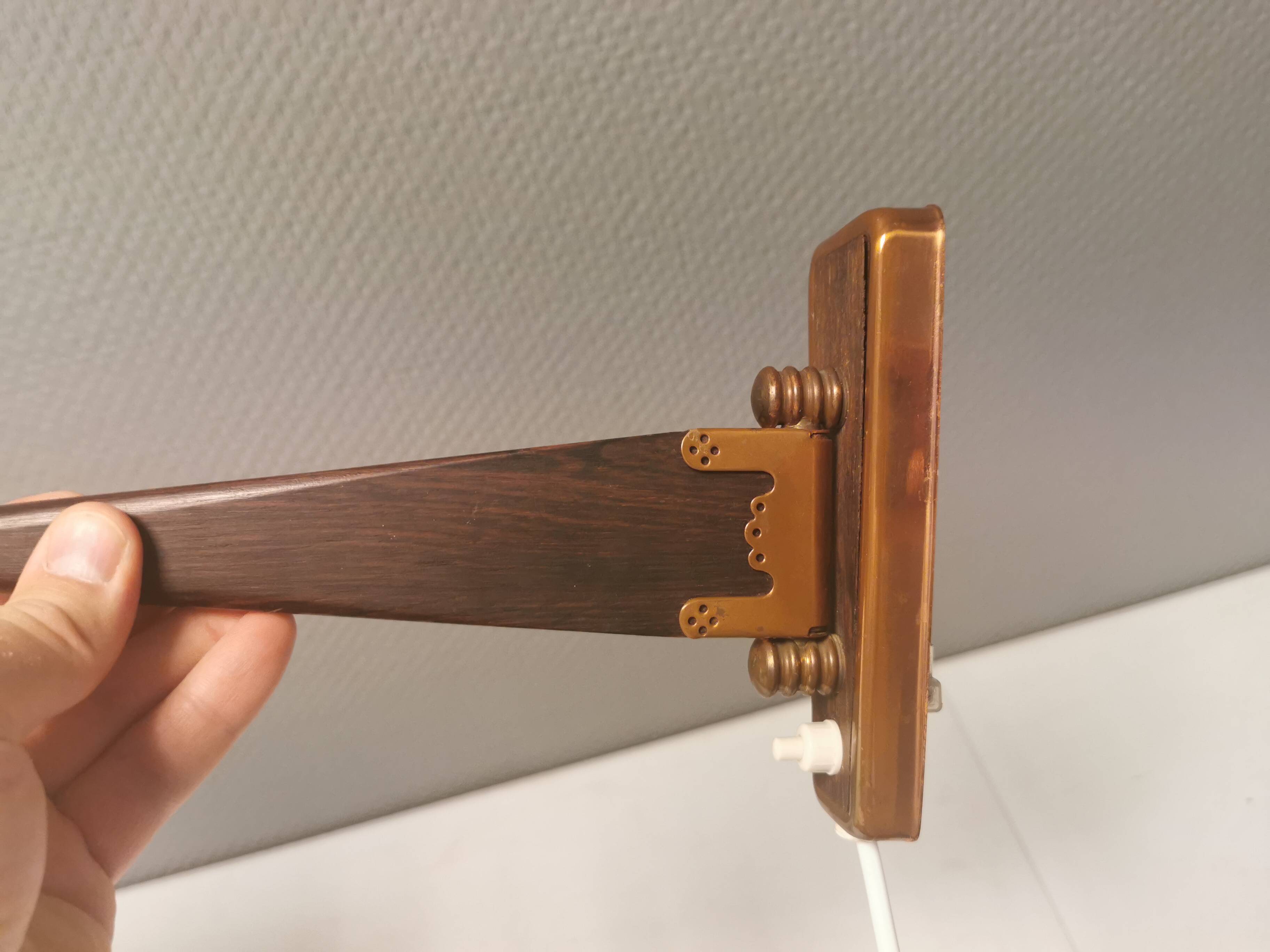 Wall lamp with adjustable ‘arm’ in copper and rosewood, with white shade.