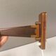 Wall lamp with adjustable ‘arm’ in copper and rosewood, with white shade.