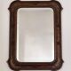 Italian sculpted mirror, patinated brown and gold wood, architectural frame from the 1960s.