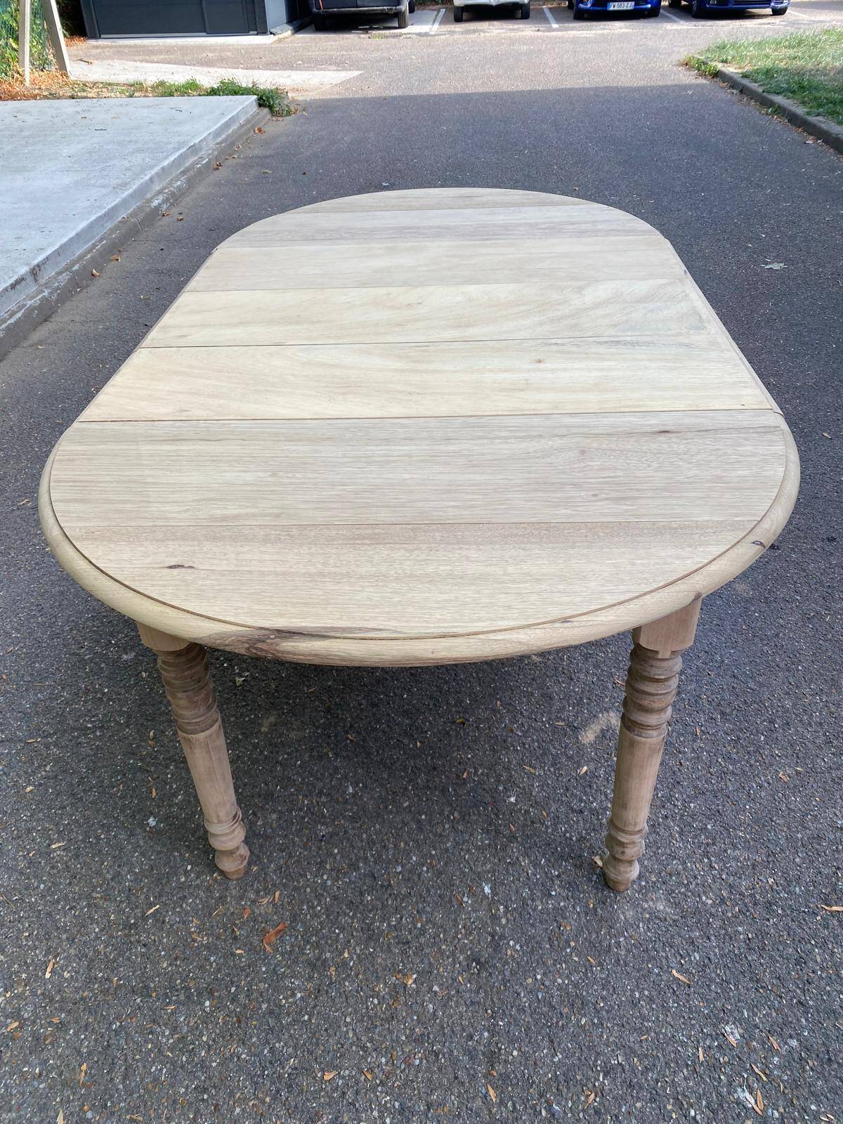 Round extendable dining table with flaps, stripped in raw oak, with 3 extensions.
