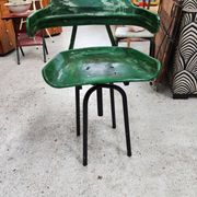 Vintage swivel workshop chair in green pressed sheet metal with a folding backrest.