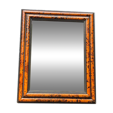 Tortoiseshell mirror and black curly wood in the style of Antwerp frames