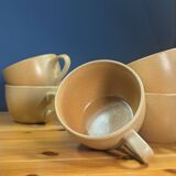 Jug and 5 cups in orange stoneware, very good condition, signed and numbered