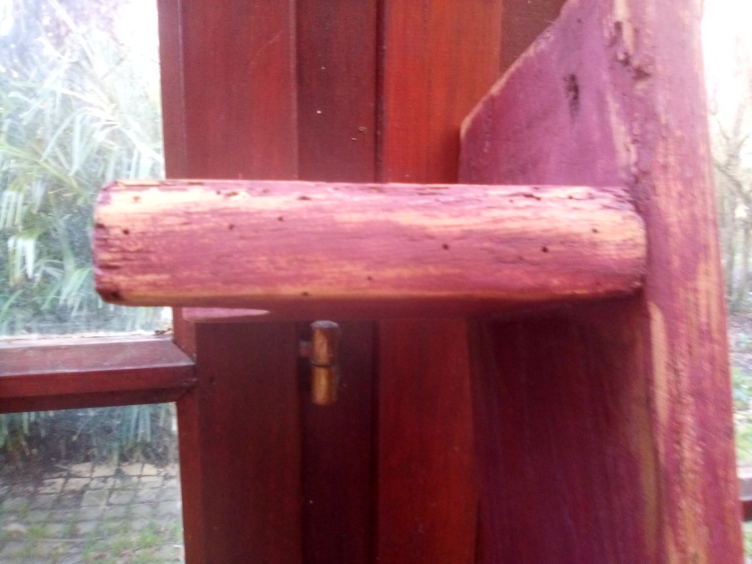 Low bench rests feet in patinated wood