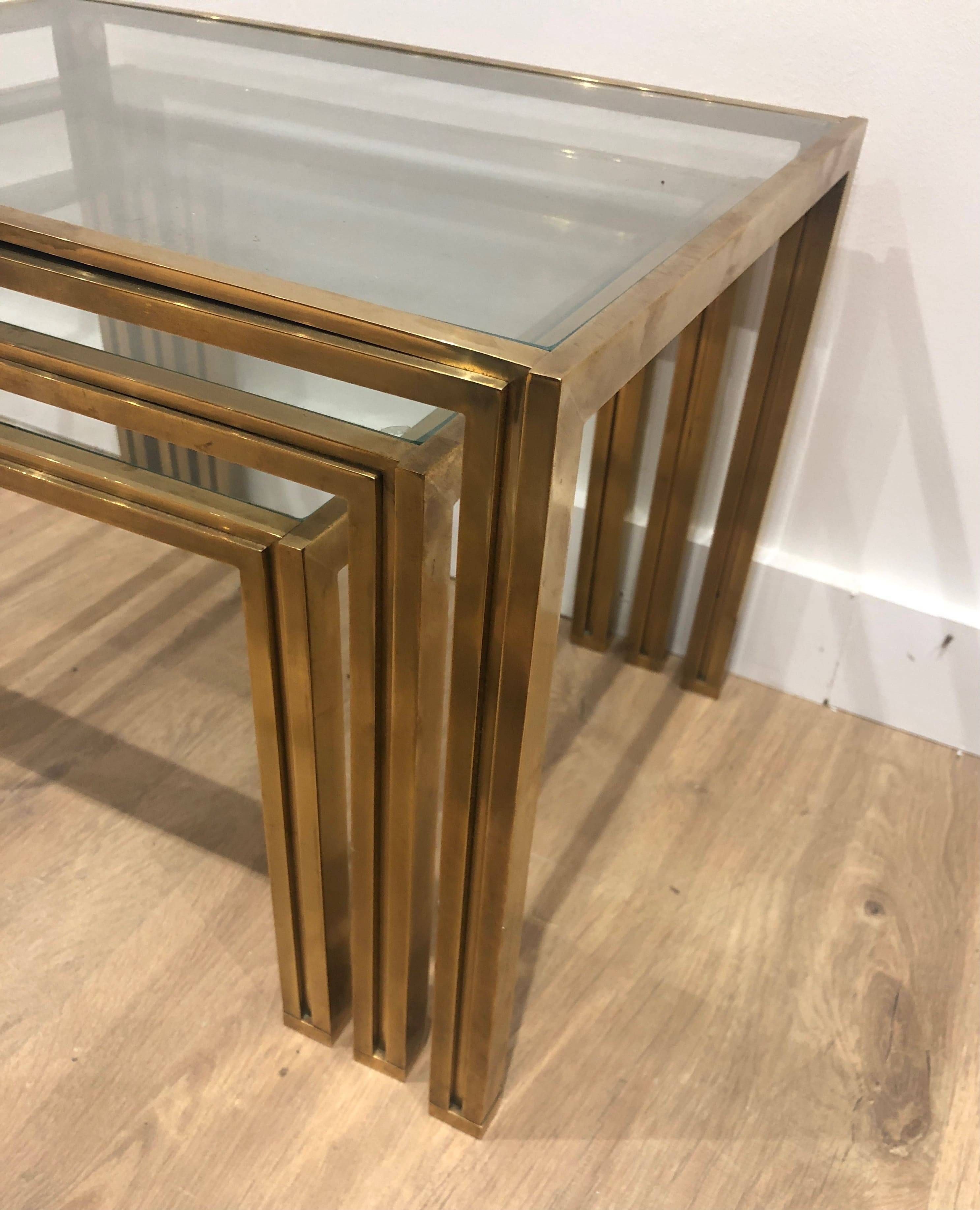 Set of 3 nesting tables in brass and glass. French work by Guy Lef.