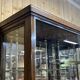 Early 20th-century shop display cabinet in oak with sliding doors.