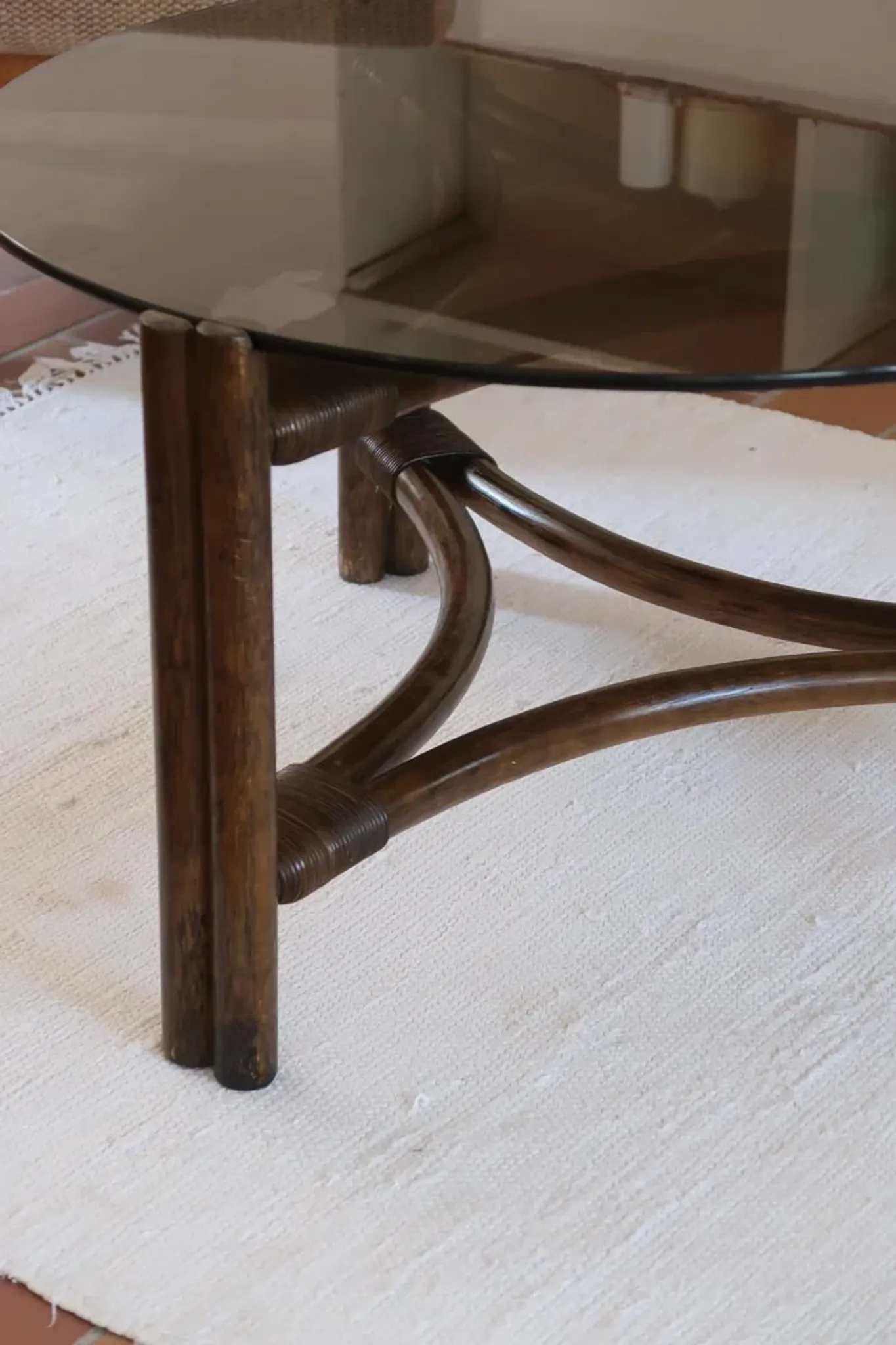 Round coffee table in rattan and smoked glass — 1970s
