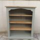 Green-grey library, wooden shelf and shelves in natural wood.