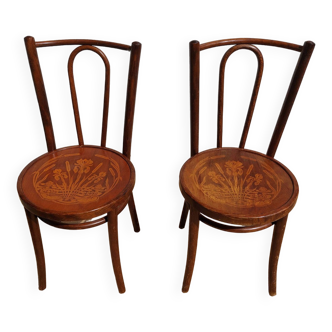 pair of bistro chairs, curved wood and pattern on the seat