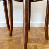 2 antique bistro stools with curved wood and caning effect.