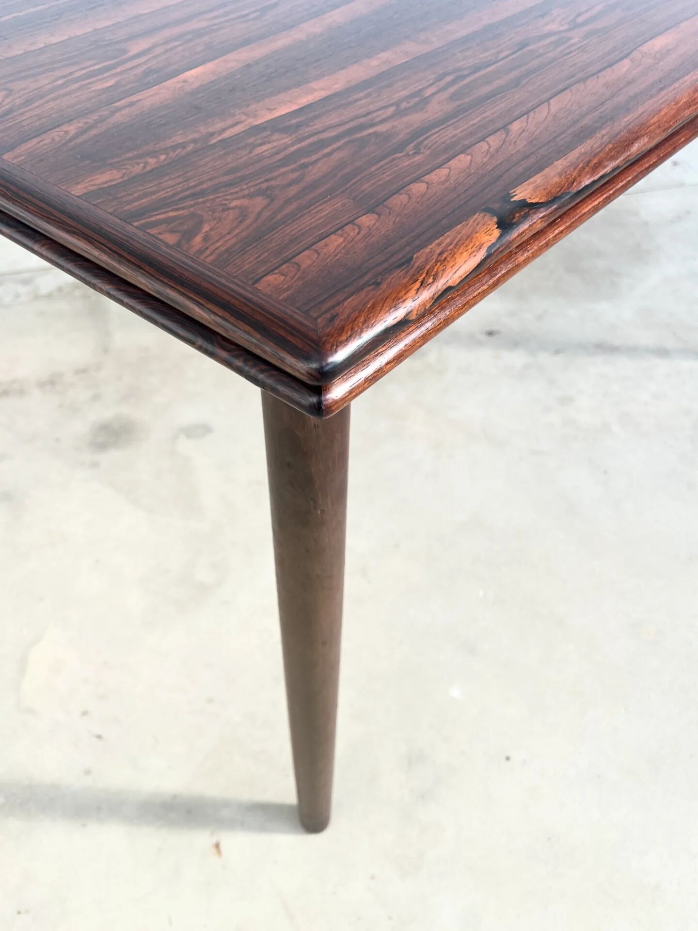 Rosewood dining table with integrated extensions — Denmark, 1960s