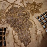 Empty pocket in openwork copper, chiseled and painted vine branches