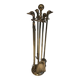 Neoclassical brass fire accessory with duck head decorations.
