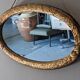 Miroir ovale Art déco en bois doré vers 1920