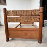 Brutalist style bed with chain and straw