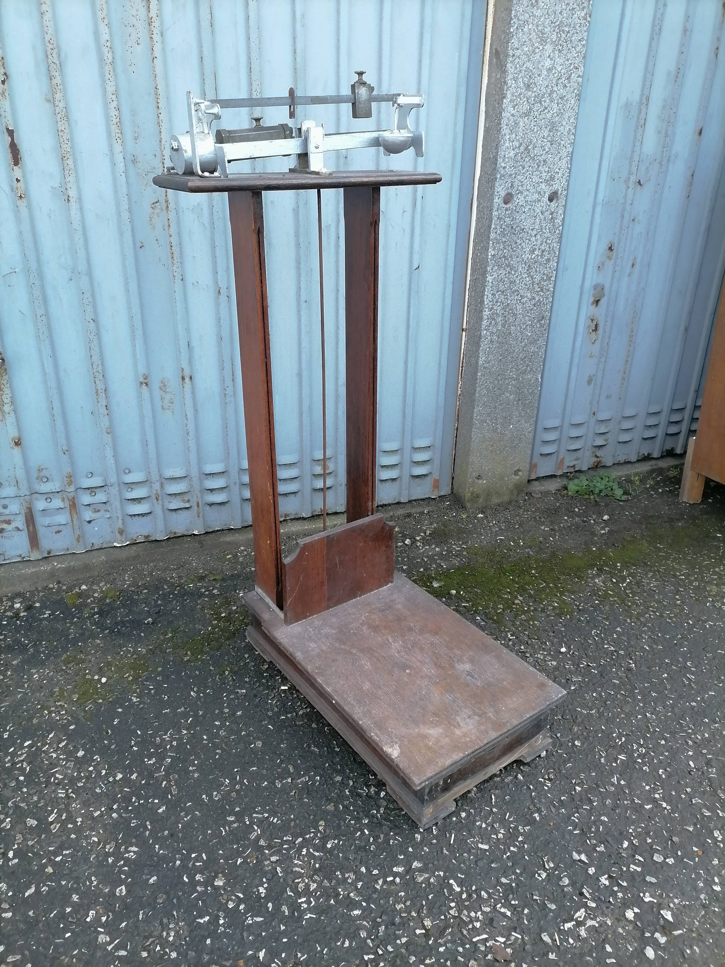 Old scale at pharmacy wood house rongier weighs person