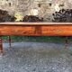 Antique cherry farmhouse table with turned legs and 2 drawers.