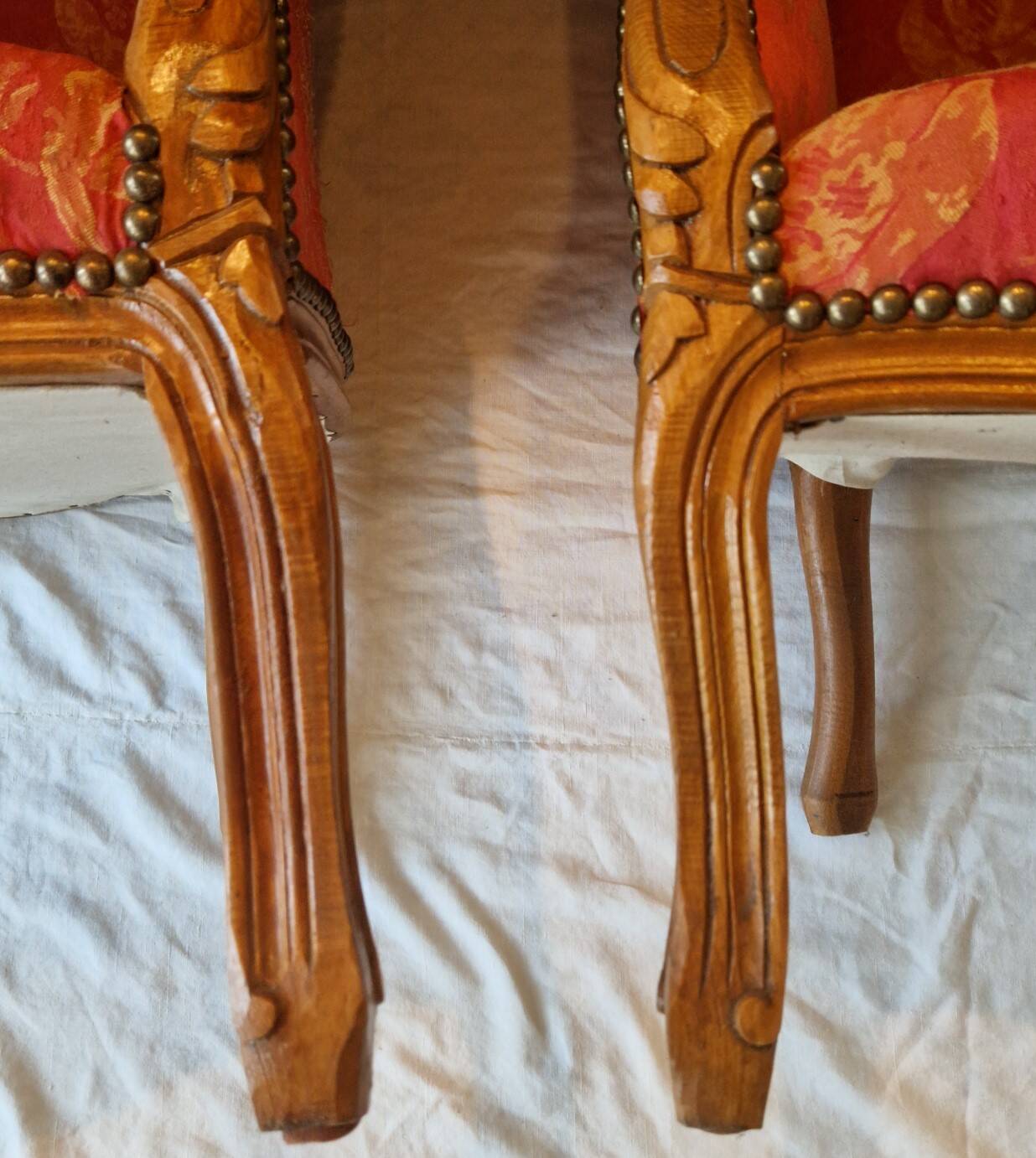 Pair of louis xv cabriolet armchairs with sculpted wood and pink & red floral fabric