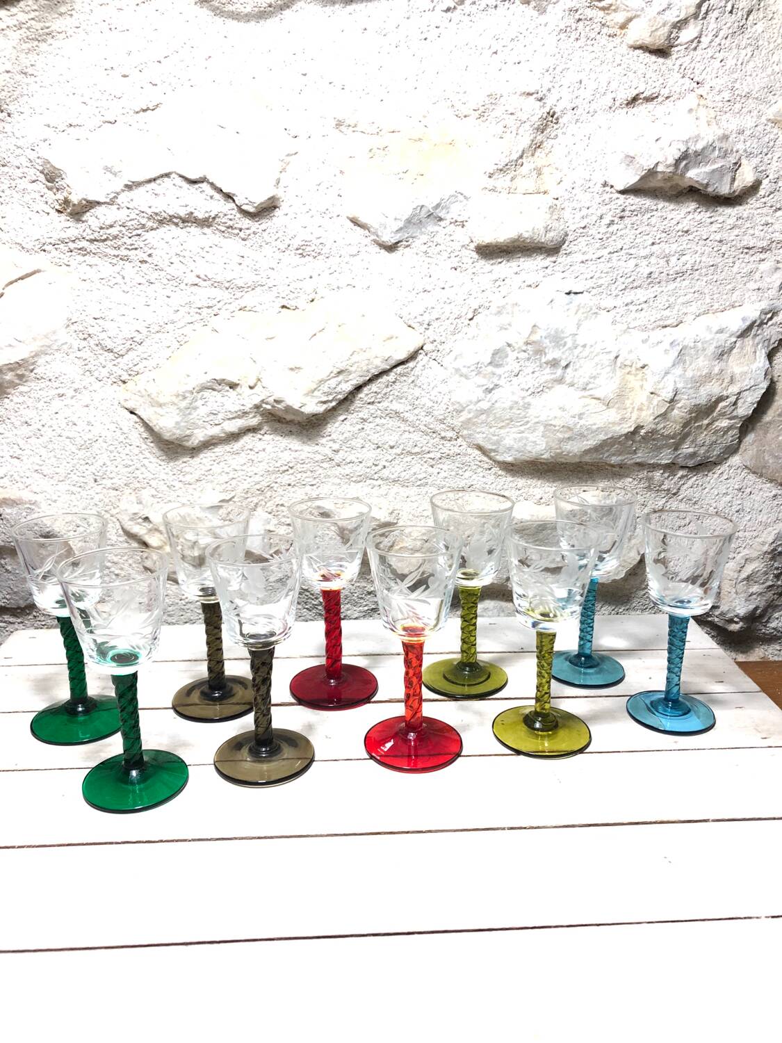 Antique and rare! Sold in a set of 12 colorful twisted stemmed glasses engraved with flowers and leaves