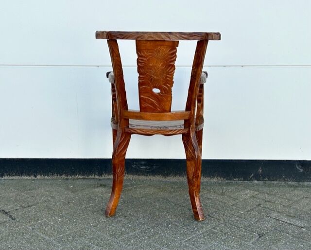 Hand stabbed teak armchair