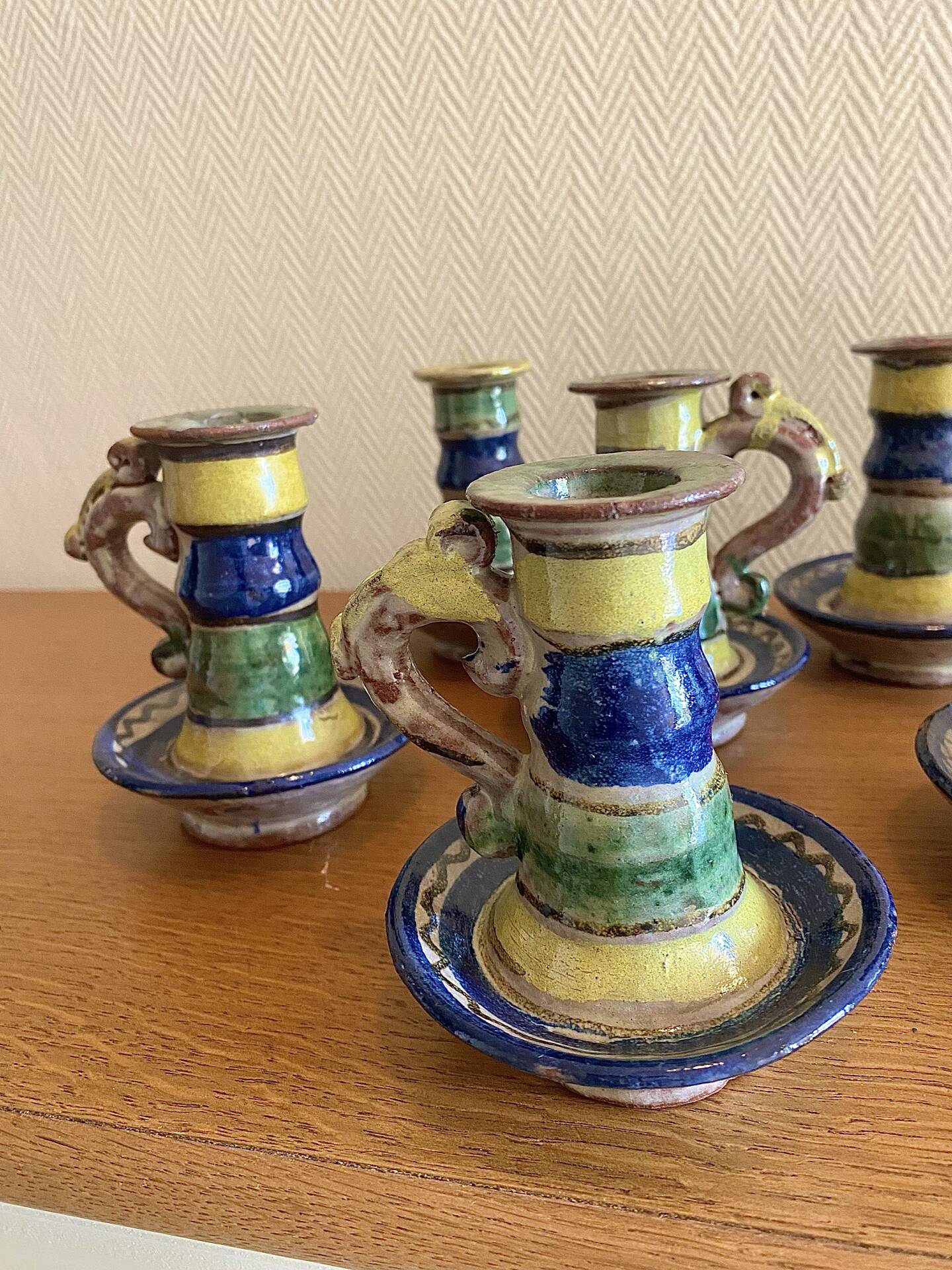 Many old glazed terracotta candlesticks.