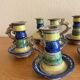 Many old glazed terracotta candlesticks.