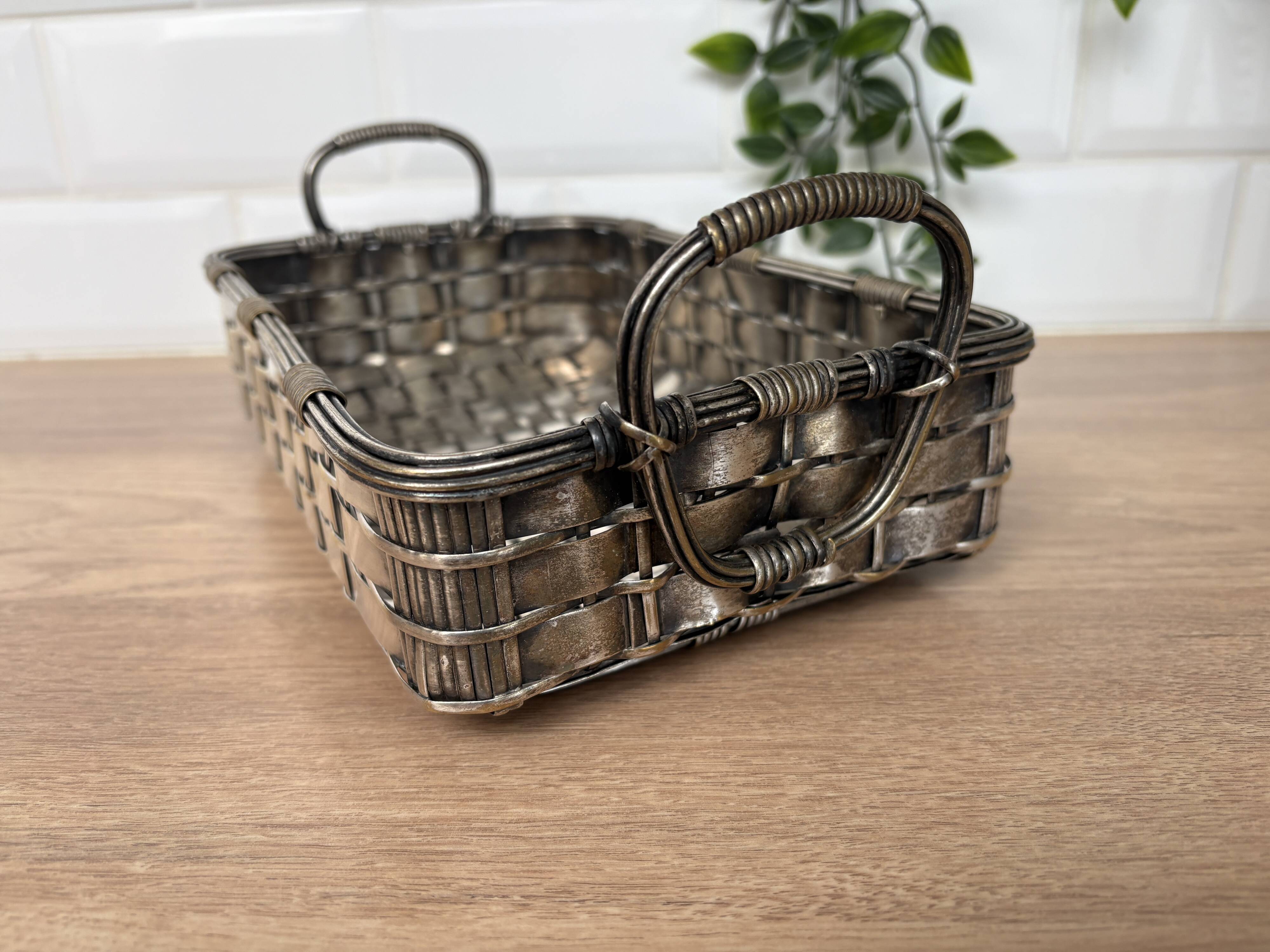 Woven silver-plated metal basket.