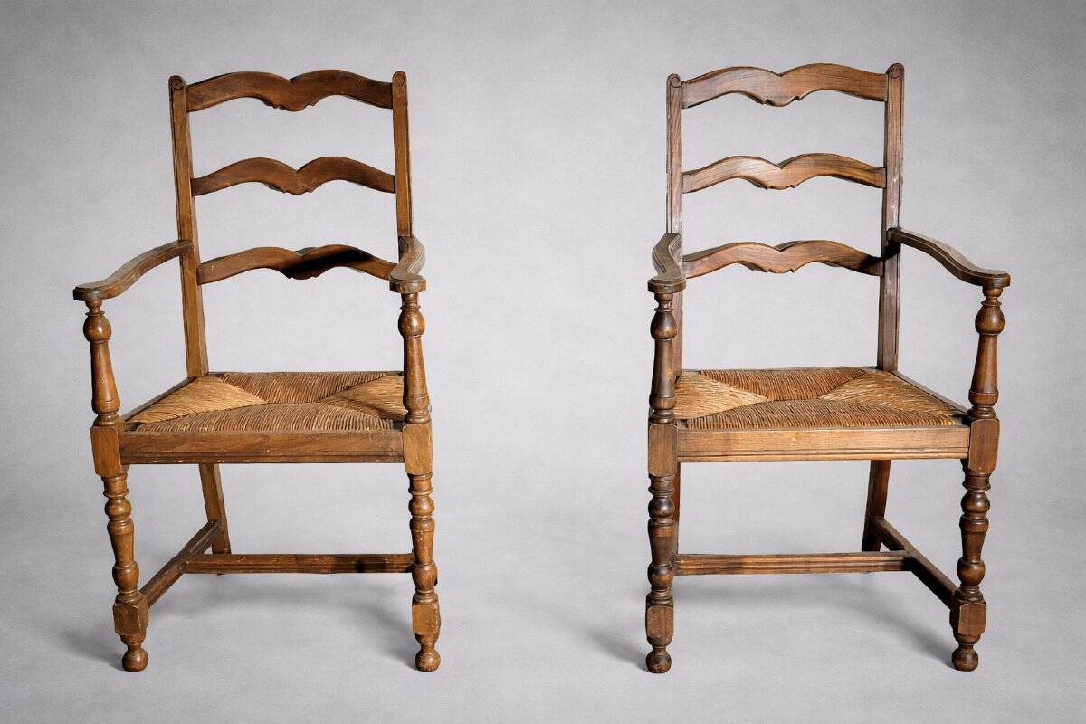 Pair of rustic antique armchairs in wood and woven straw.