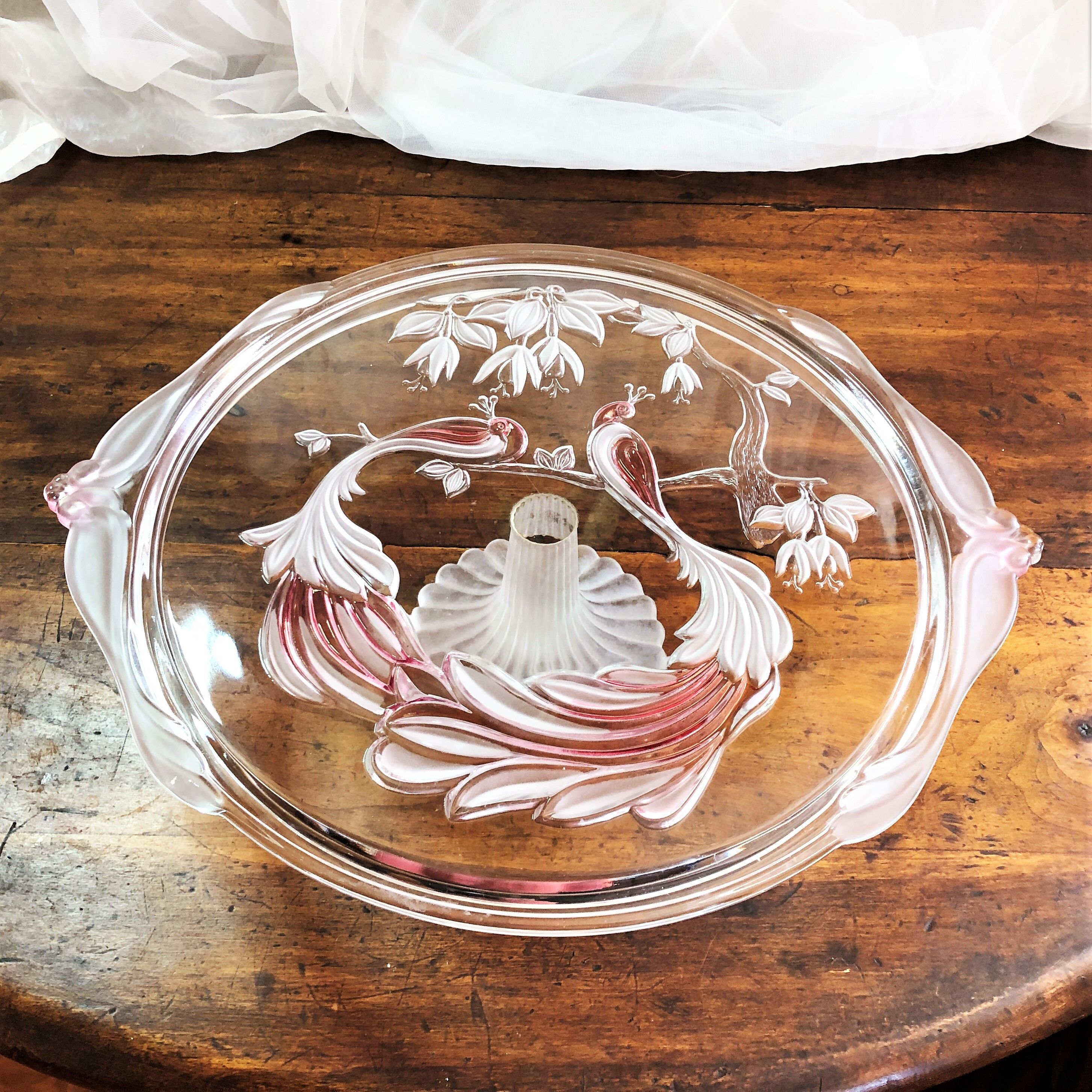 Large pie dish cakes on pedestal decorated with peacocks
