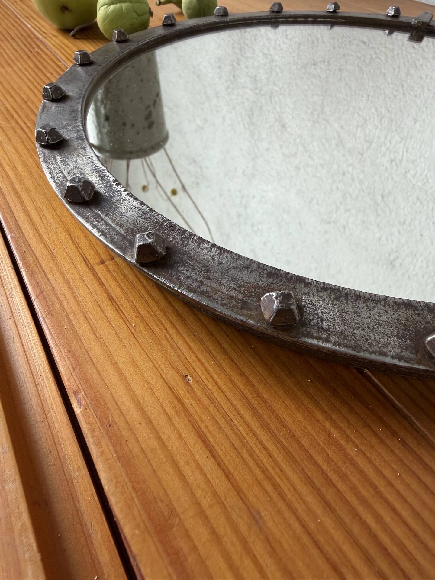 Brutalist round mirror with wrought iron and studs.