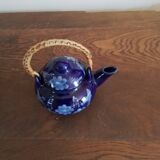 Small blue teapot and its wicker handle