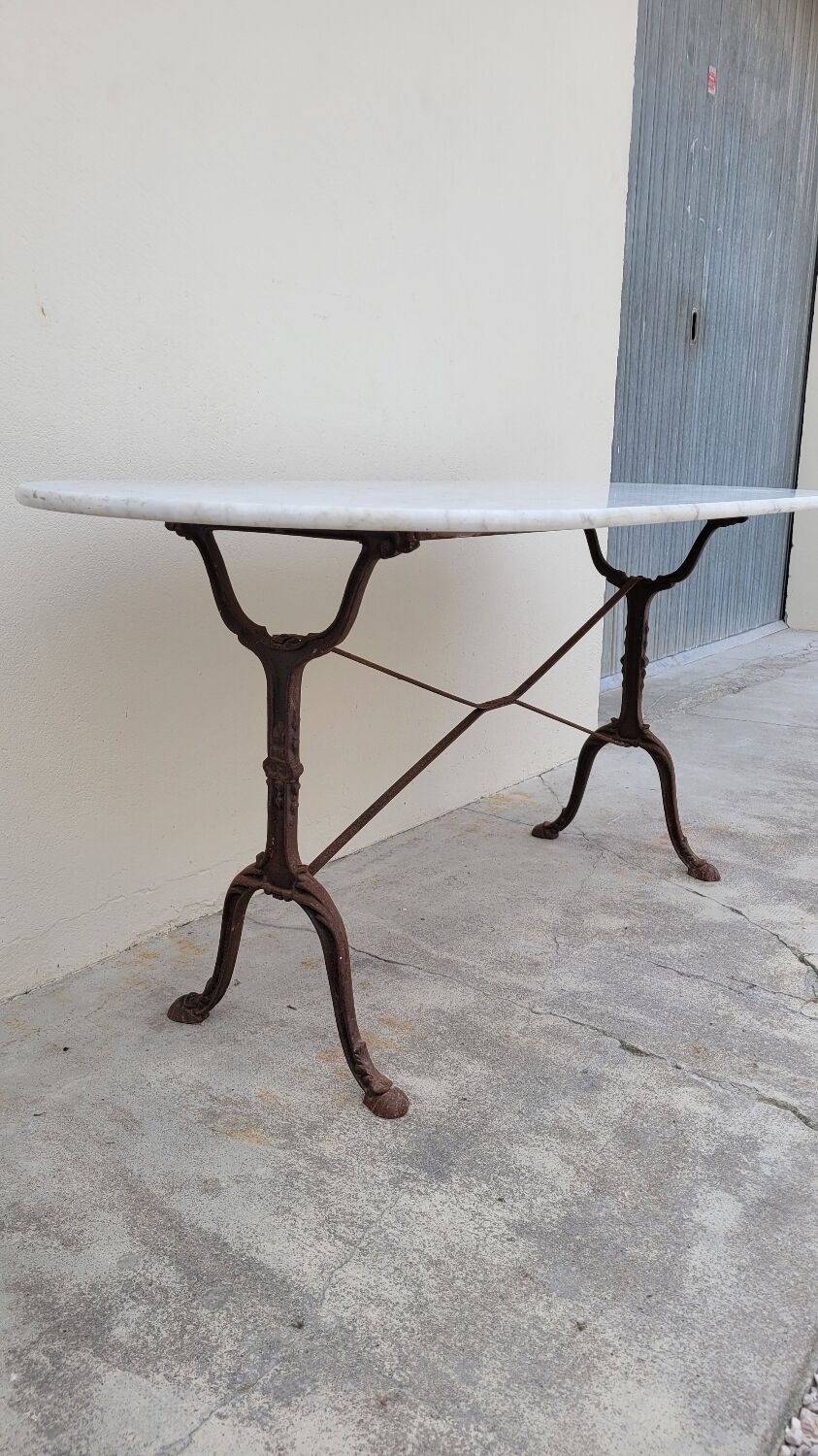 Restaurant bistro table in oval marble and decorated cast iron bases -1m51