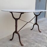 Restaurant bistro table in oval marble and decorated cast iron bases -1m51