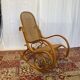 Antique rocking chair in curved wood and caning.