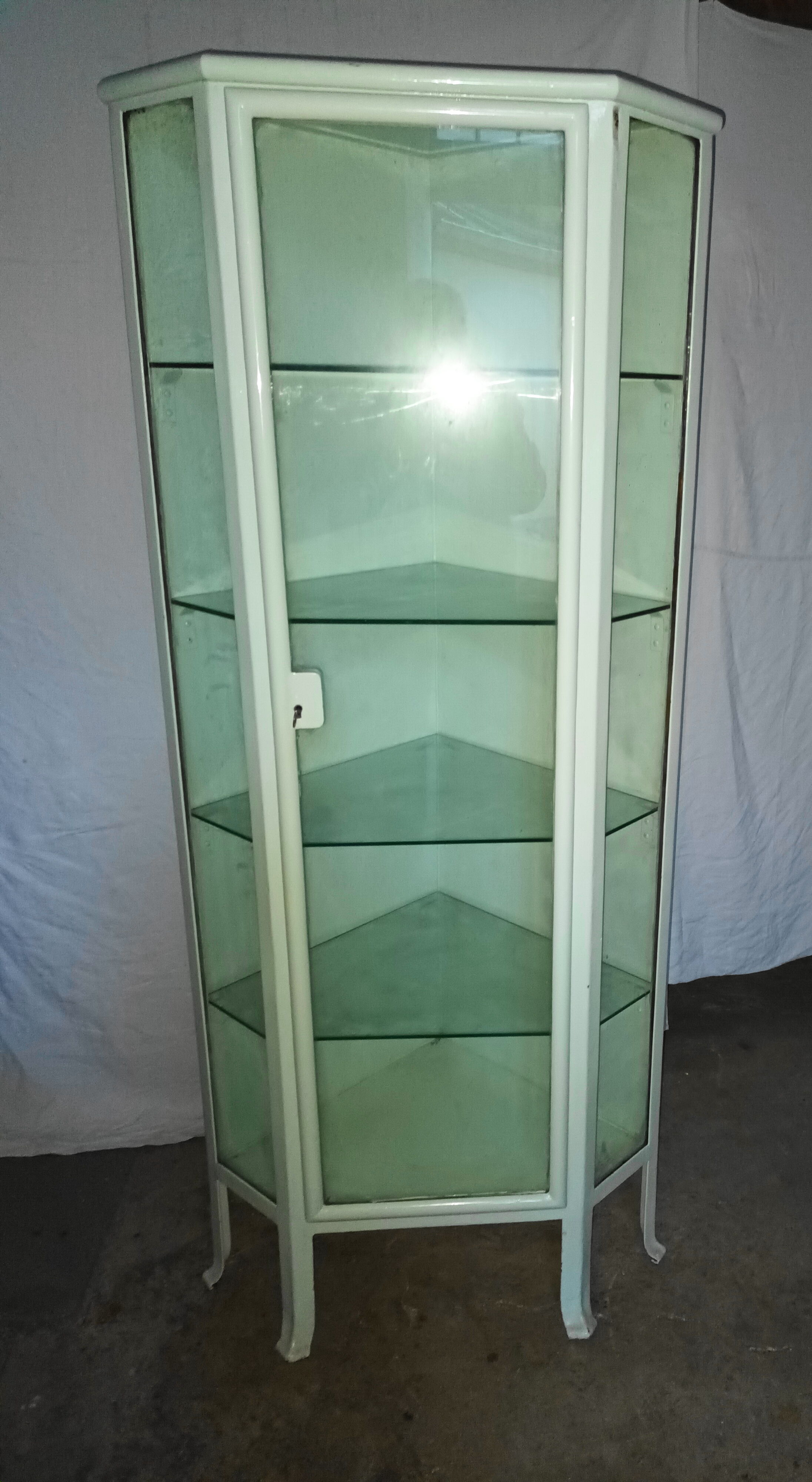 Painted metal ophthalmologist's corner display case, early 20th century