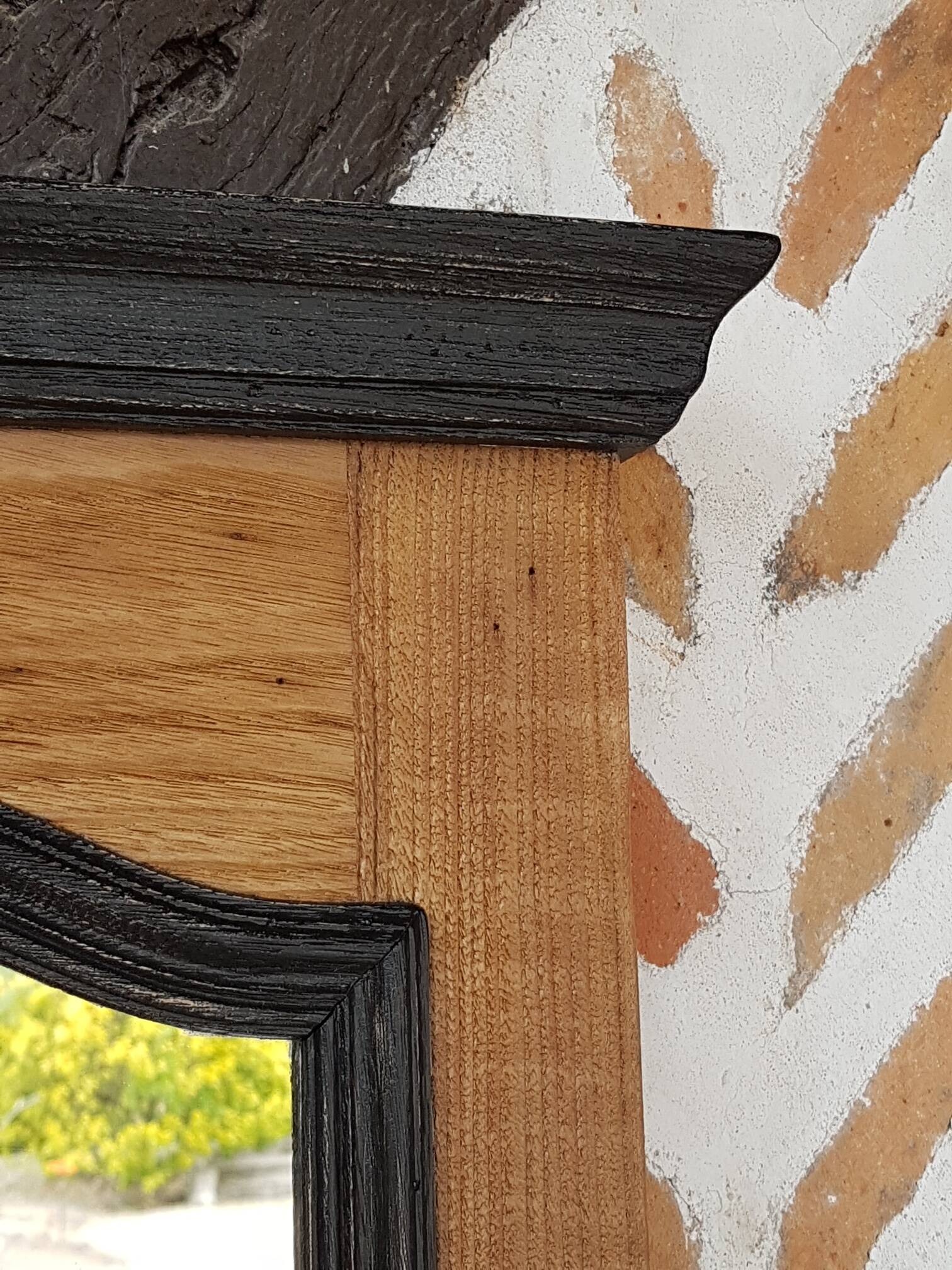 Black mirror and raw natural wood