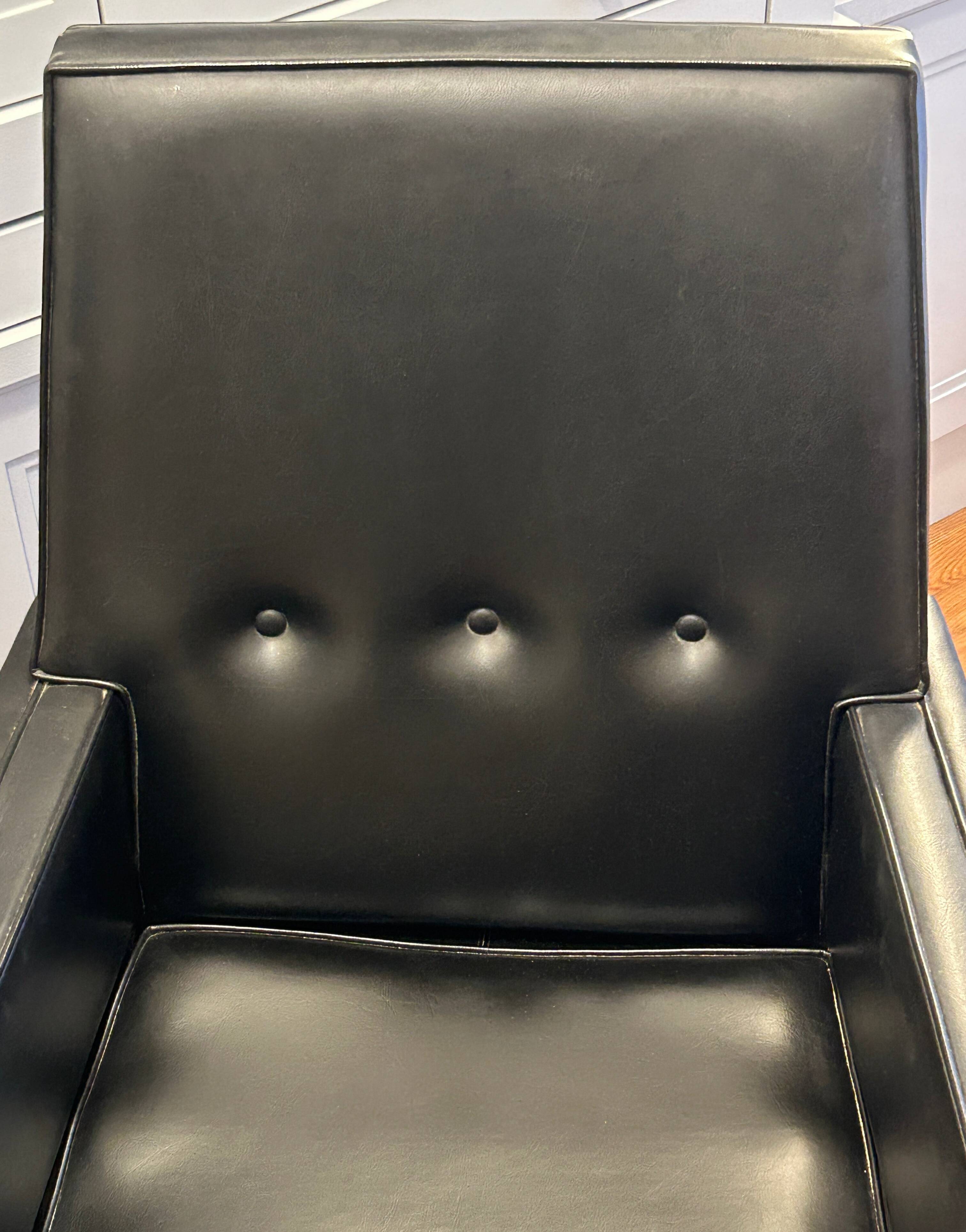 Modernist armchair in wood and black synthetic leather, circa 1960