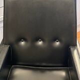 Modernist armchair in wood and black synthetic leather, circa 1960