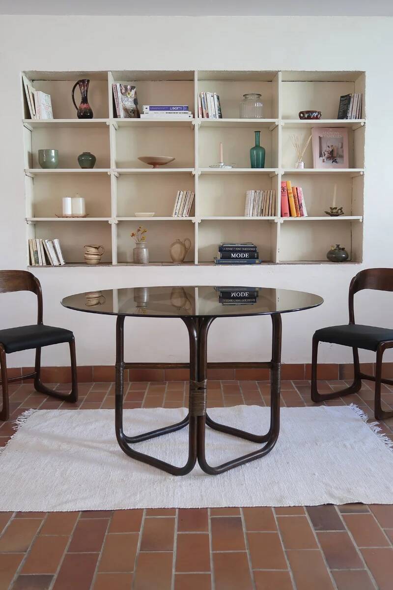 Round dining table in rattan, smoked glass top, 1970s.