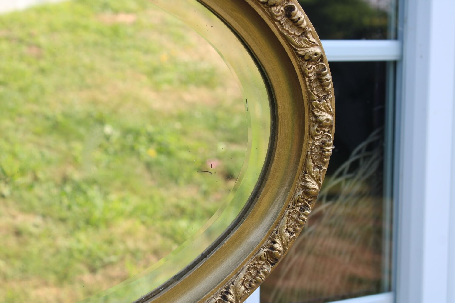 Bevelled oval antique mirror