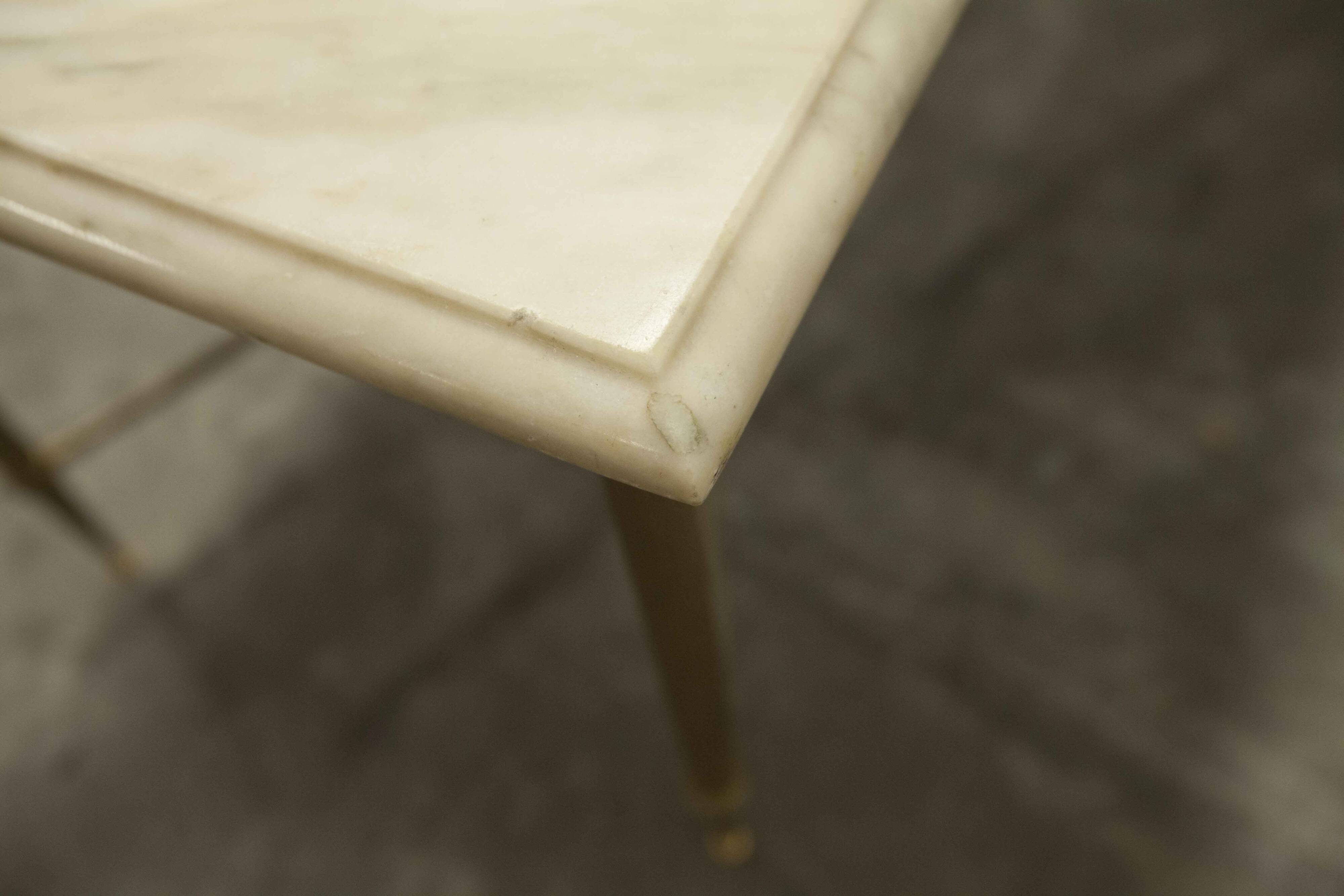 Marble coffee table with brass legs, height 46 cm.