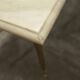 Marble coffee table with brass legs, height 46 cm.