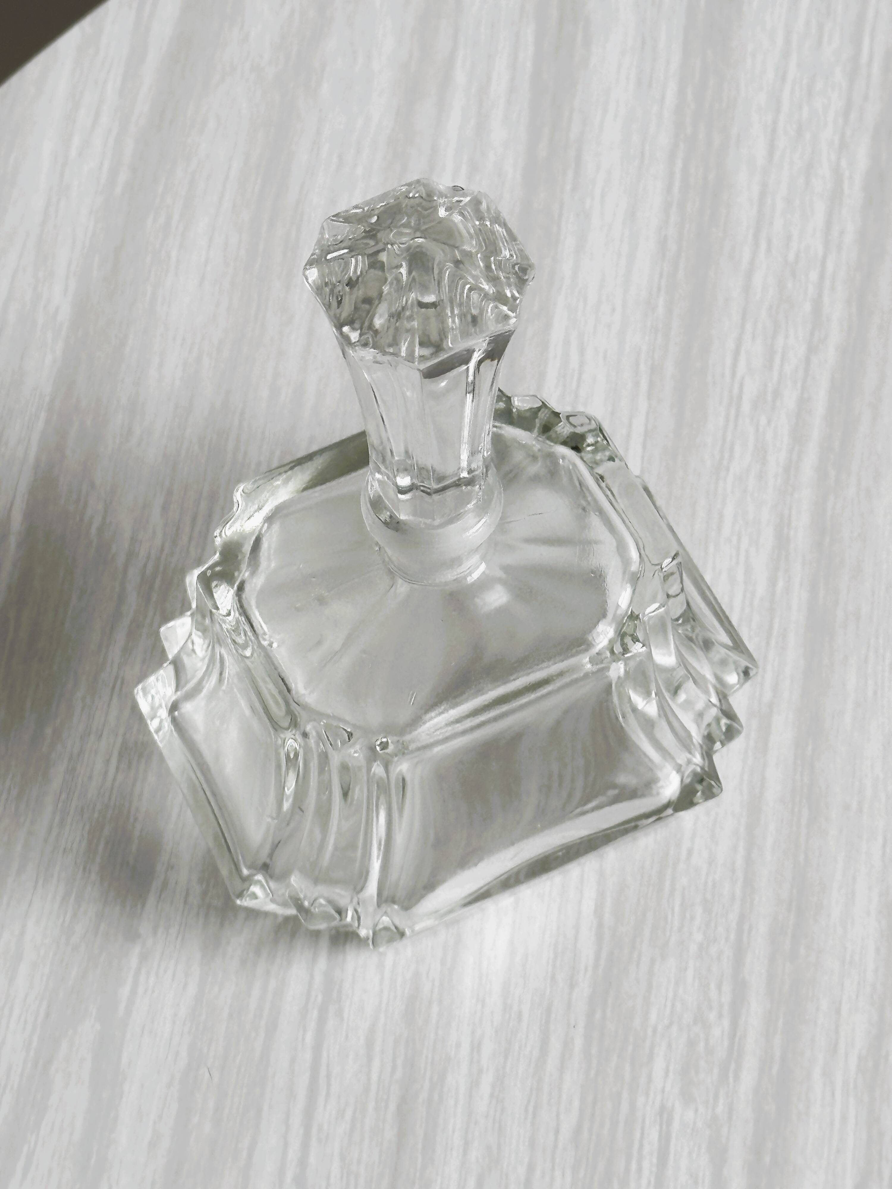 Small transparent faceted glass bottle