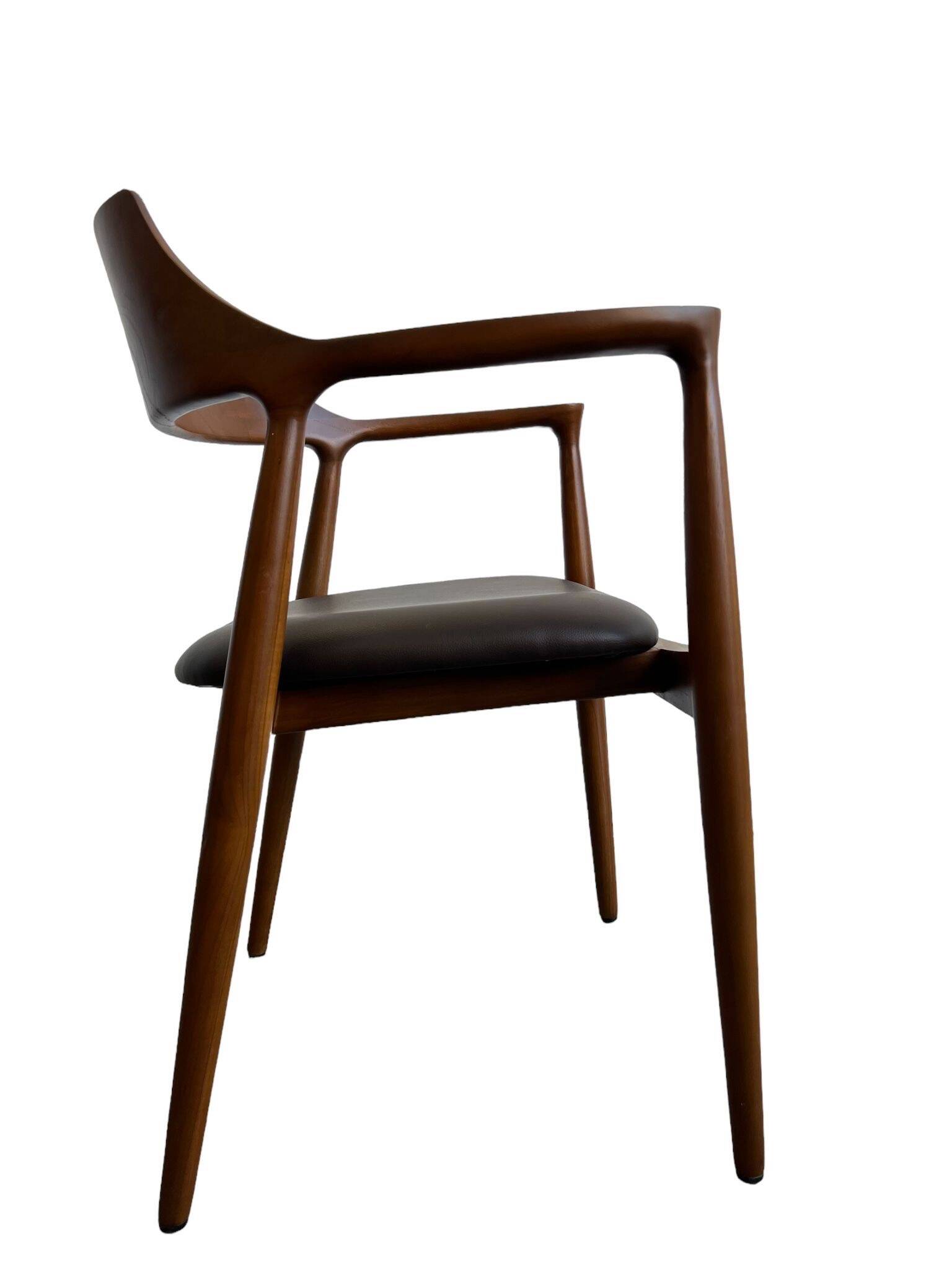 Curved wooden dining chair with brown leather seat