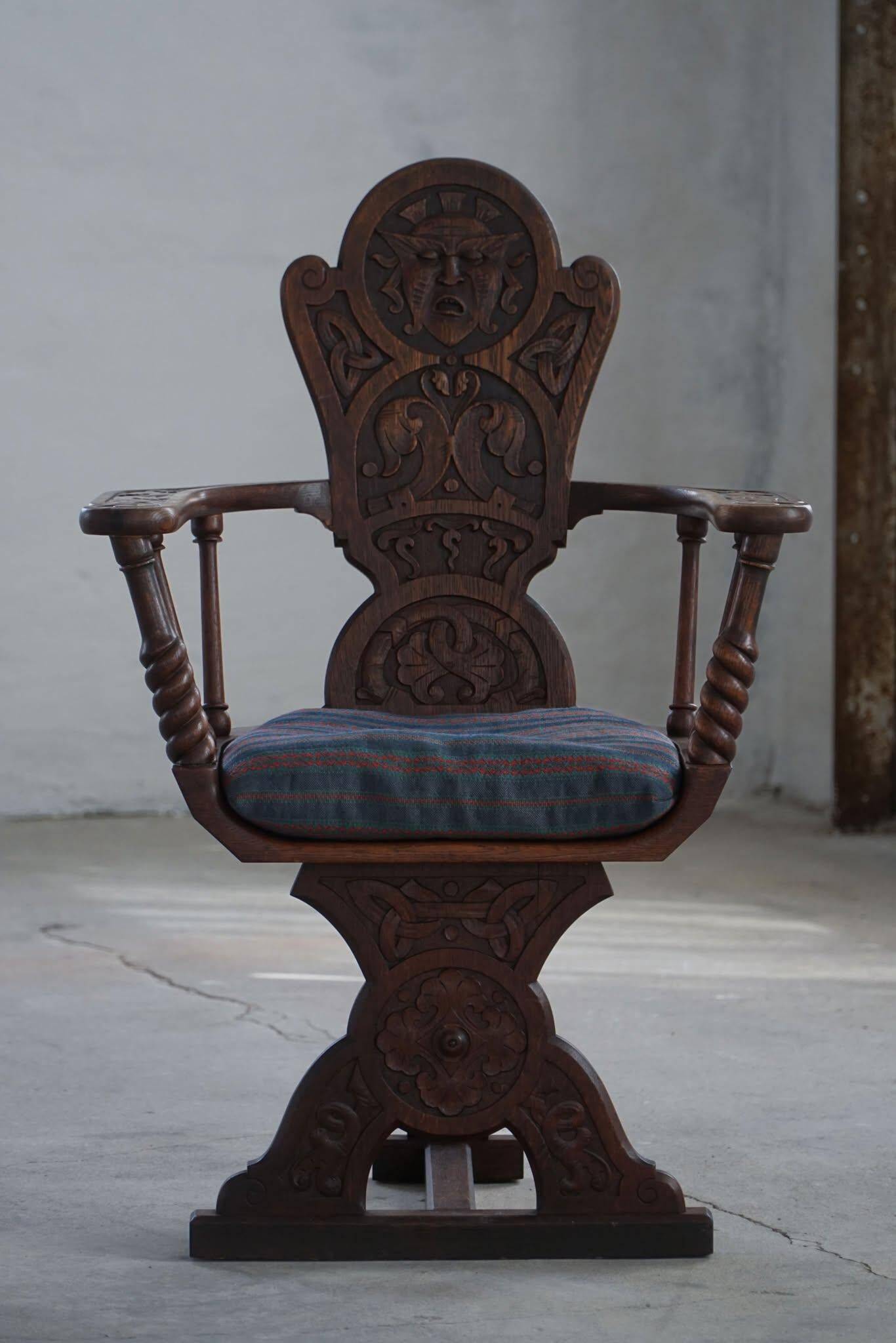 Scandinavian armchair in solid oak with cushion, folk art, early 19th century.