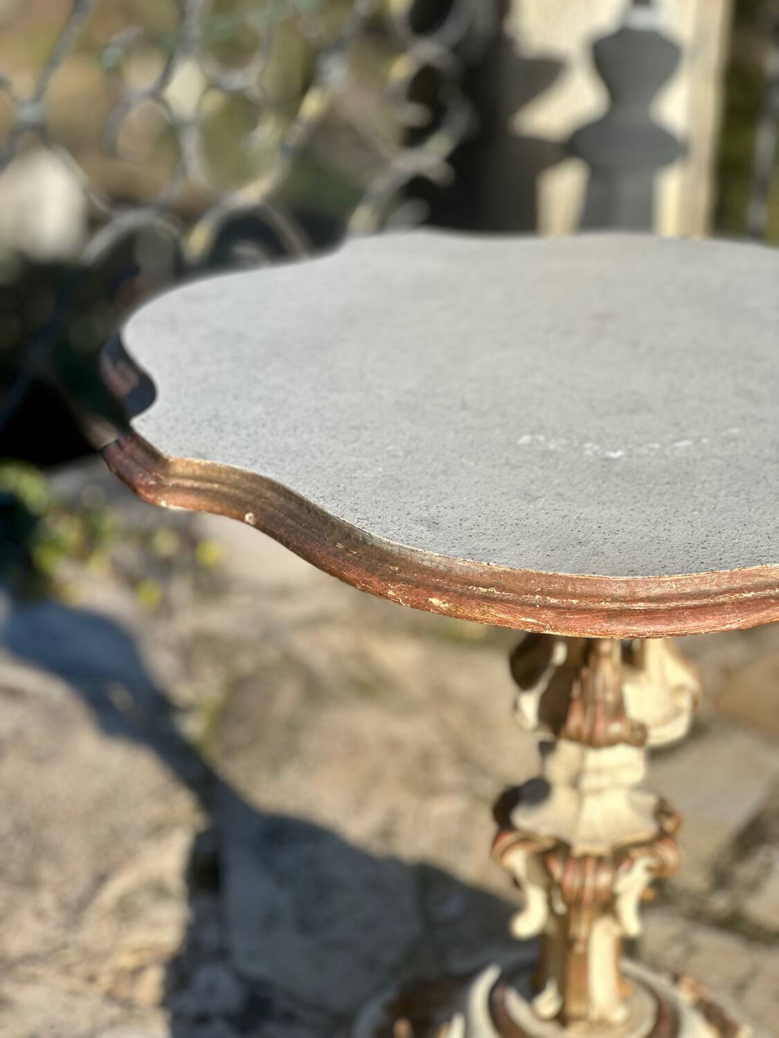 Carved and lacquered wooden side table.